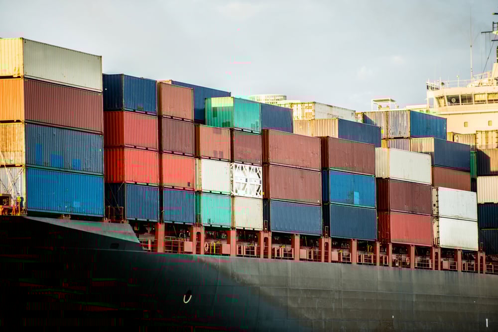Trade boat carrying containers and arriving at the port Trade boat carrying containers and arriving at the port